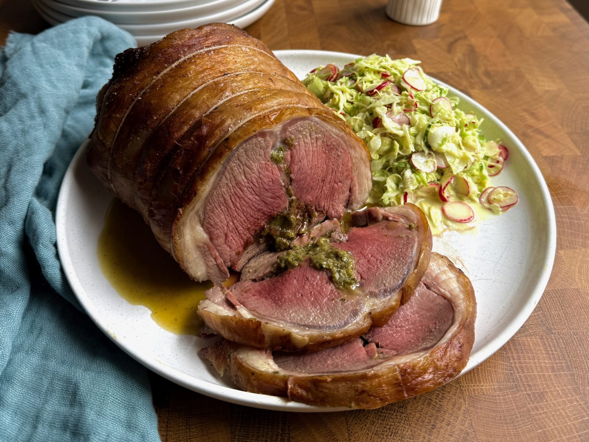 Rolled lamb saddle with herby pickled onion stuffing and spring cabbage remoulade